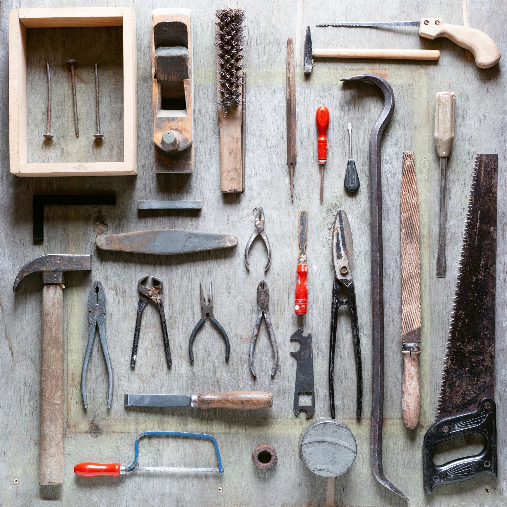 Hand tools arranged on a wooden surface